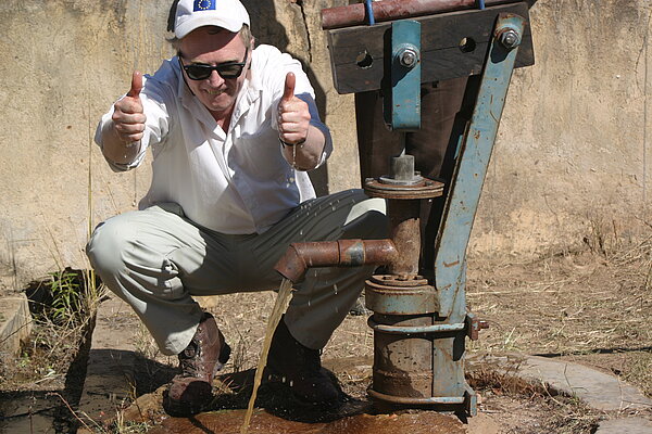Brian posing with a water pump